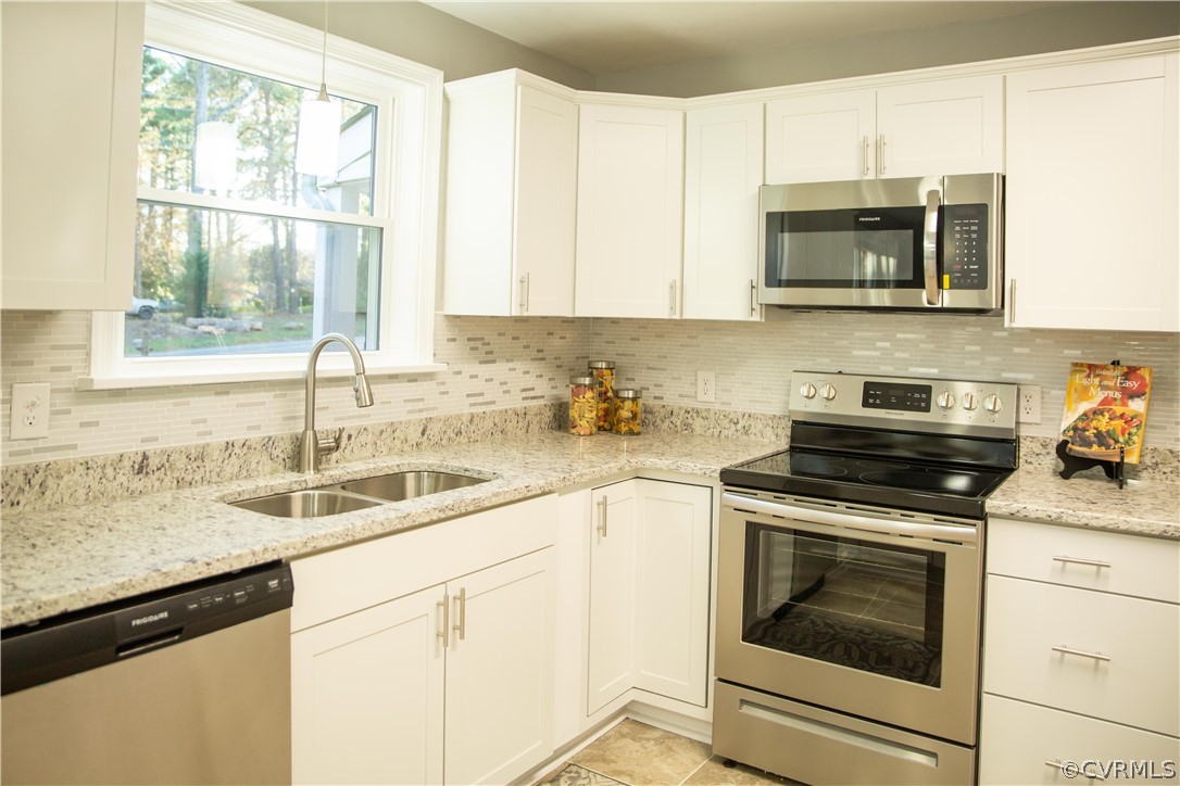 8530 Cherokee Road Richmond, VA 23235 - Photo 5 of 40 a kitchen with granite countertop white cabinets stainless steel appliances and a sink