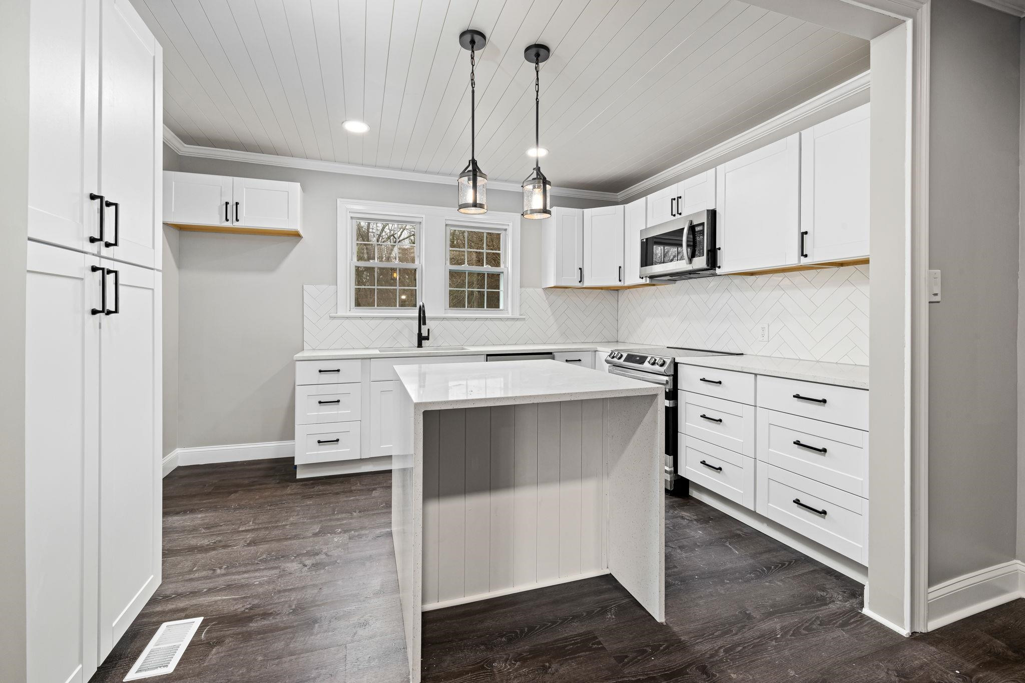 1716 Chapel Hill Road Durham, NC 27707 - Photo 14 of 33 a kitchen with stainless steel appliances a sink and cabinets