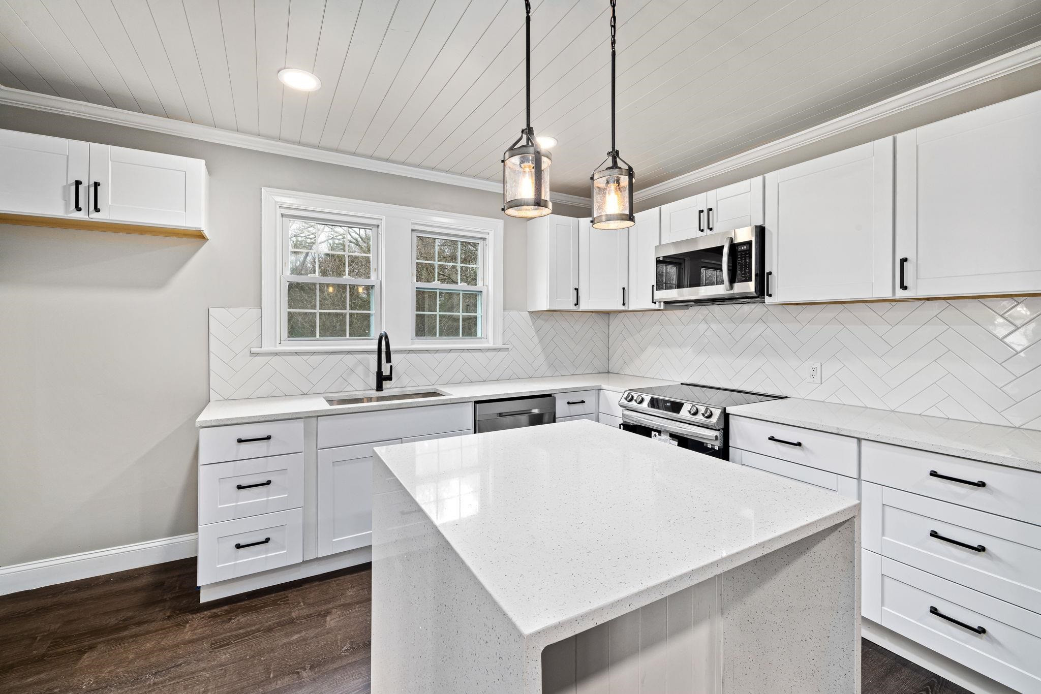 1716 Chapel Hill Road Durham, NC 27707 - Photo 16 of 33 a kitchen with a white cabinets and window