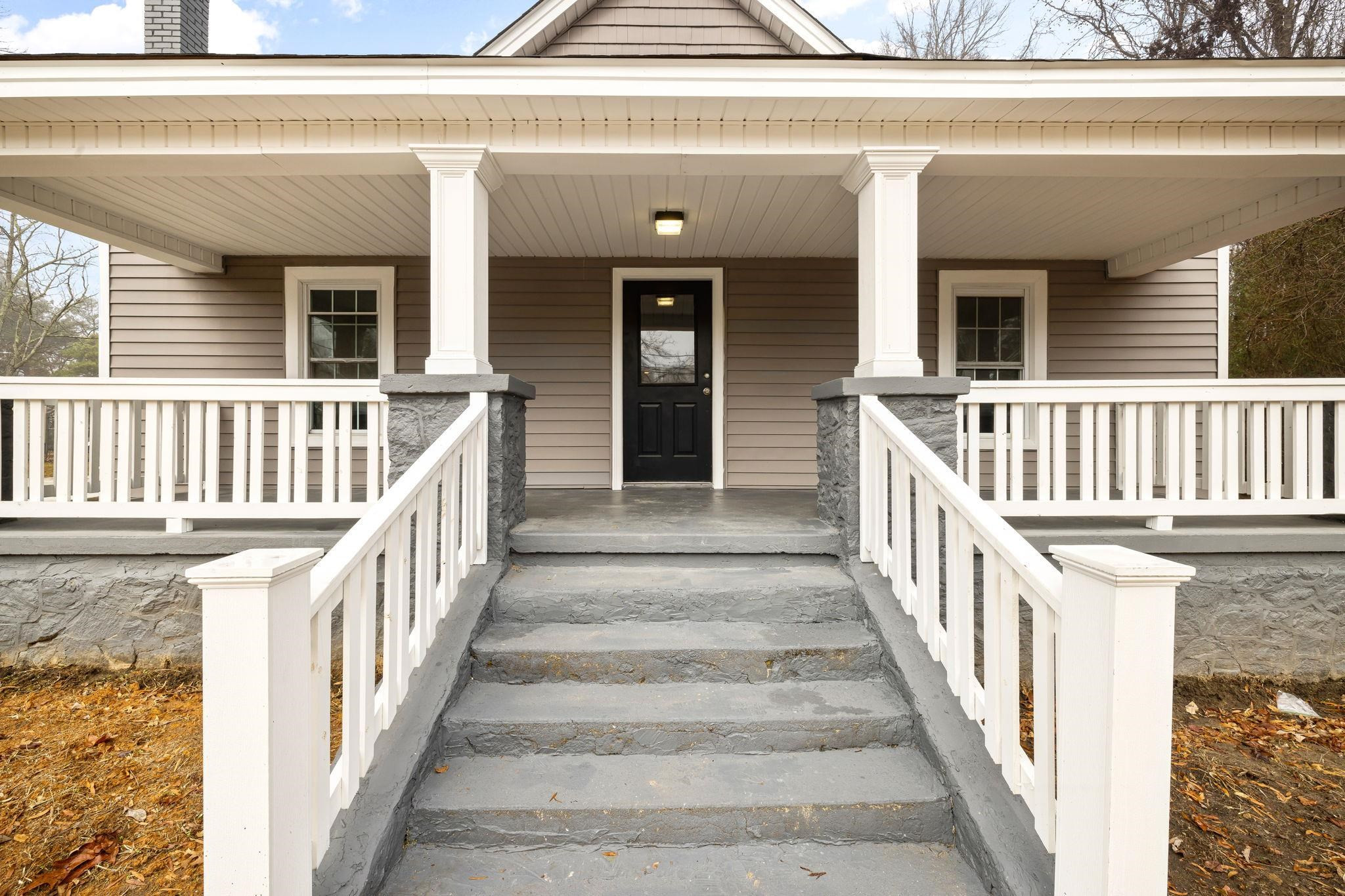 1716 Chapel Hill Road Durham, NC 27707 - Photo 4 of 33 a view of staircase with lots of frames on wall and a large window