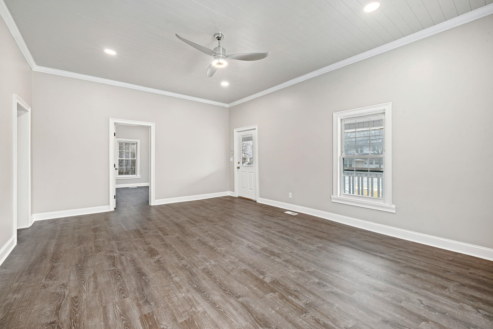 1716 Chapel Hill Road Durham, NC 27707 - Photo 7 of 33 a view of an empty room with wooden floor and a window