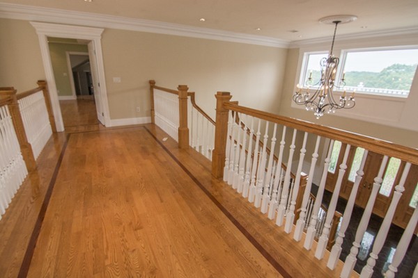68 Coppermine Road Topsfield, MA 01983 - Photo 6 of 30 a view of a hallway with wooden floor and stairs