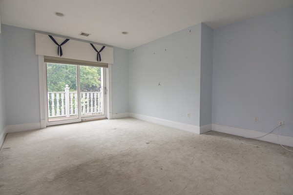 68 Coppermine Road Topsfield, MA 01983 - Photo 7 of 30 a view of a big room with windows and chandelier fan