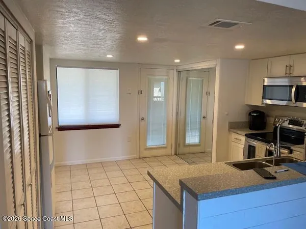 a kitchen with a sink stove and microwave