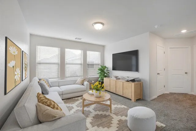 a living room with furniture and a large window