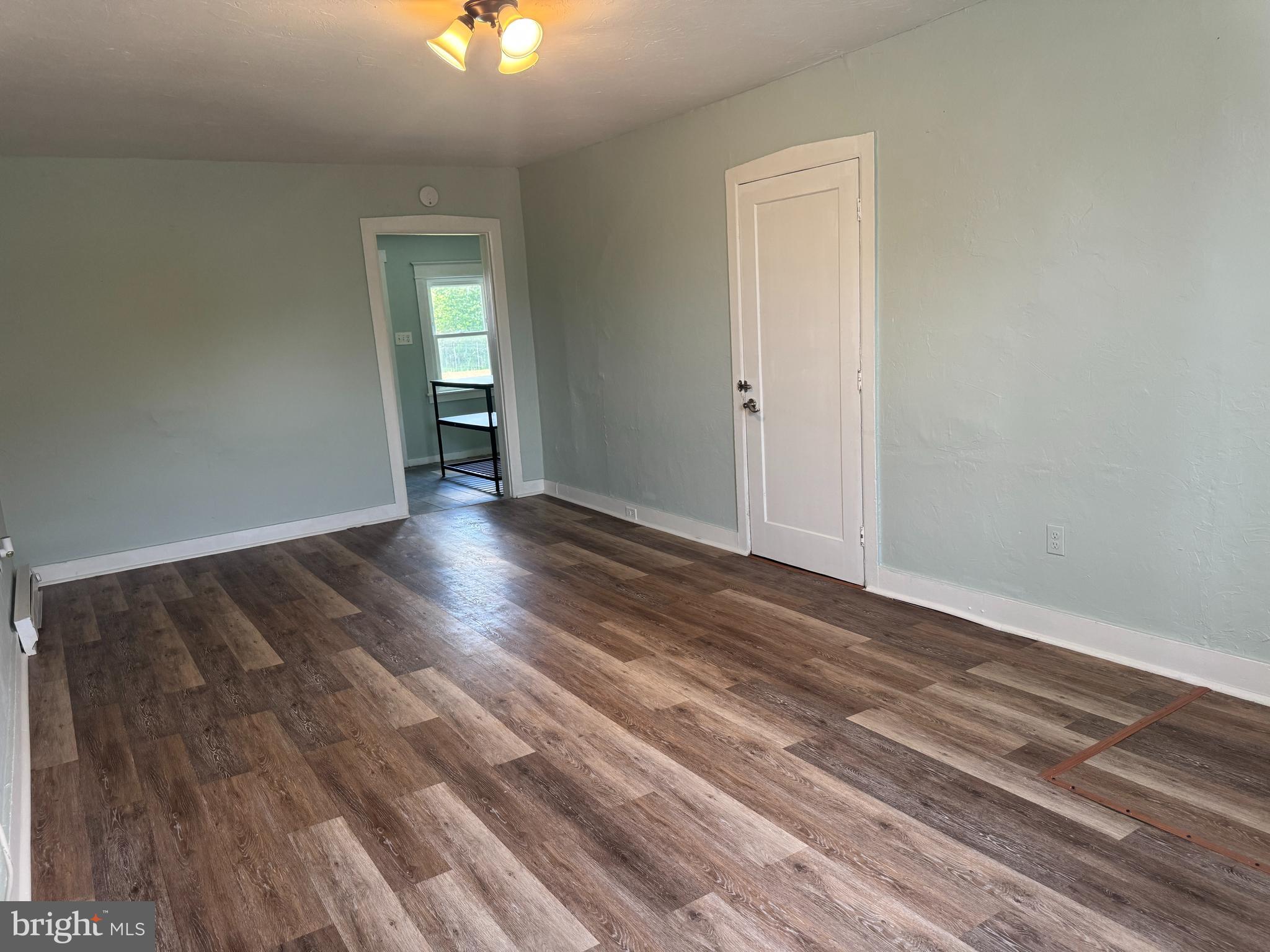 3754 Baltimore Pike, Unit 3 Littlestown, PA 17340 - Photo 7 of 21 a view of an empty room with wooden floor and a window