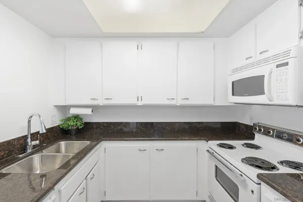 a kitchen with stainless steel appliances a refrigerator and a cabinets