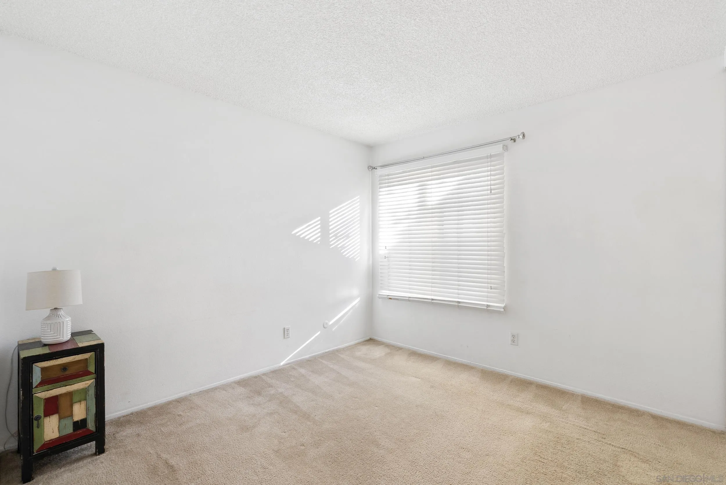 5978 Rancho Mission Road, Unit 274 San Diego, CA 92108 - Photo 18 of 23 a view of an empty room with a window