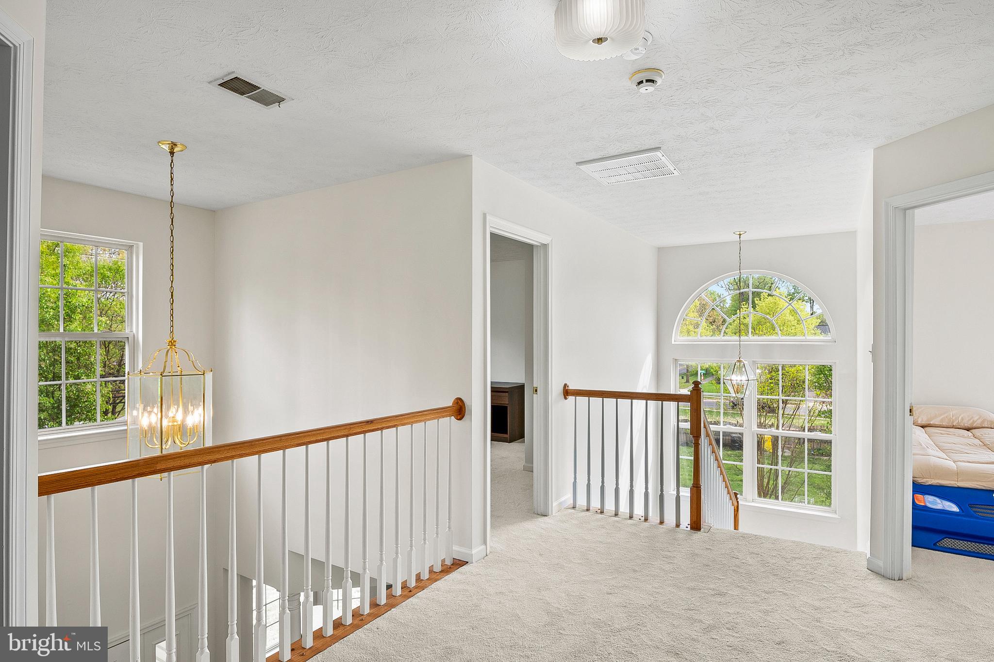 456 North Patuxent Road Odenton, MD 21113 - Photo 18 of 44 a view of a hallway with windows and chandelier