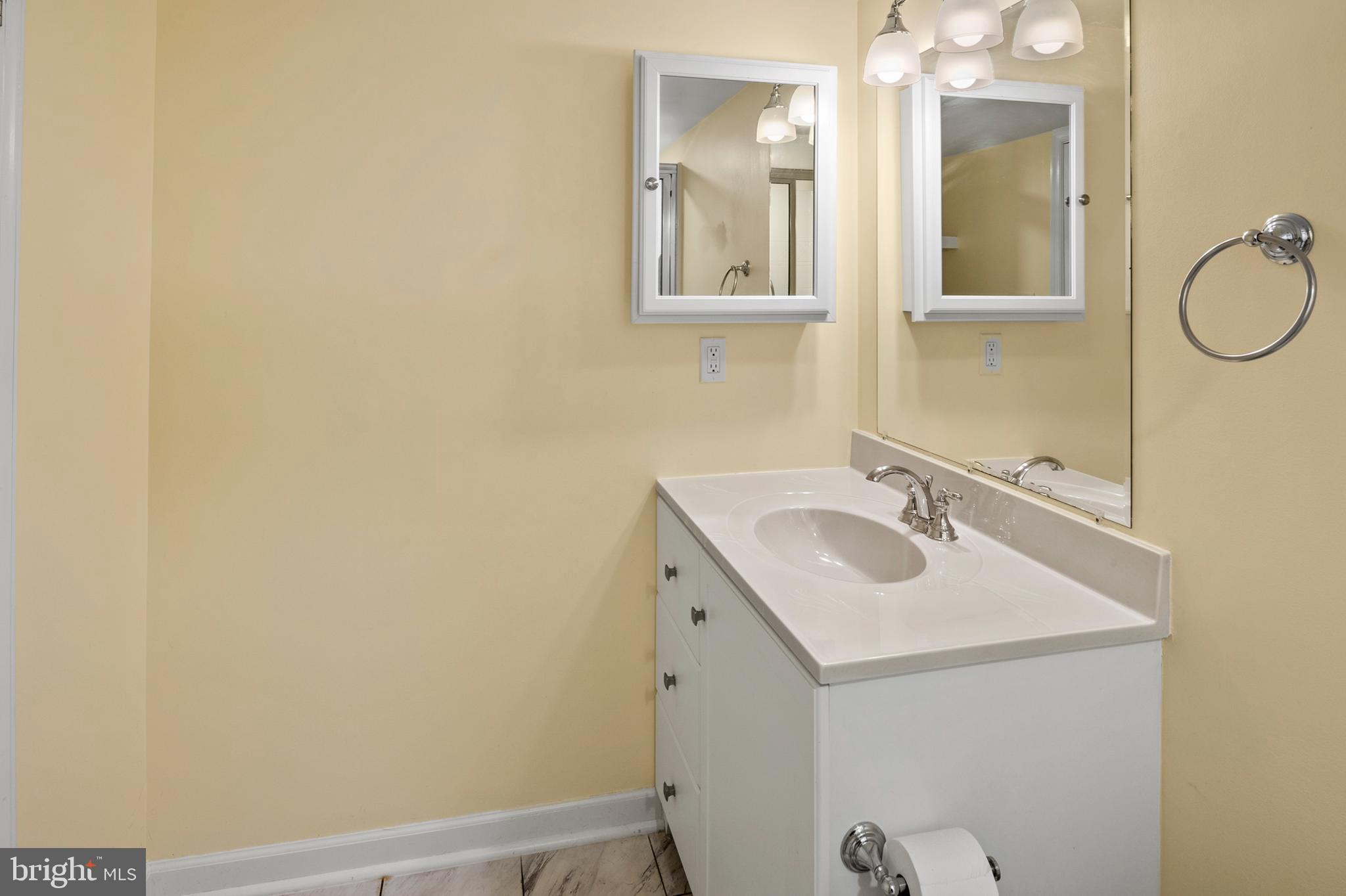 456 North Patuxent Road Odenton, MD 21113 - Photo 34 of 44 a bathroom with a sink and mirror