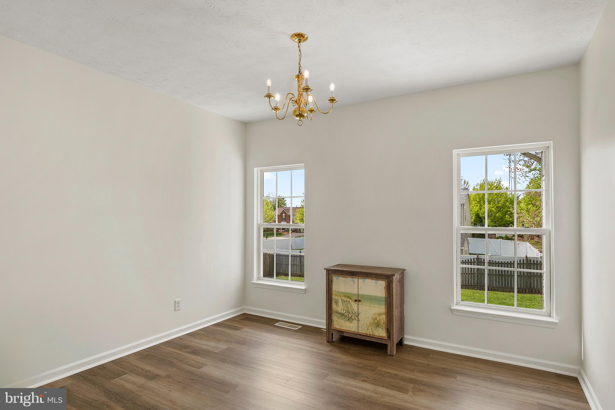 456 North Patuxent Road Odenton, MD 21113 - Photo 7 of 44 an empty room with wooden floor chandelier and windows