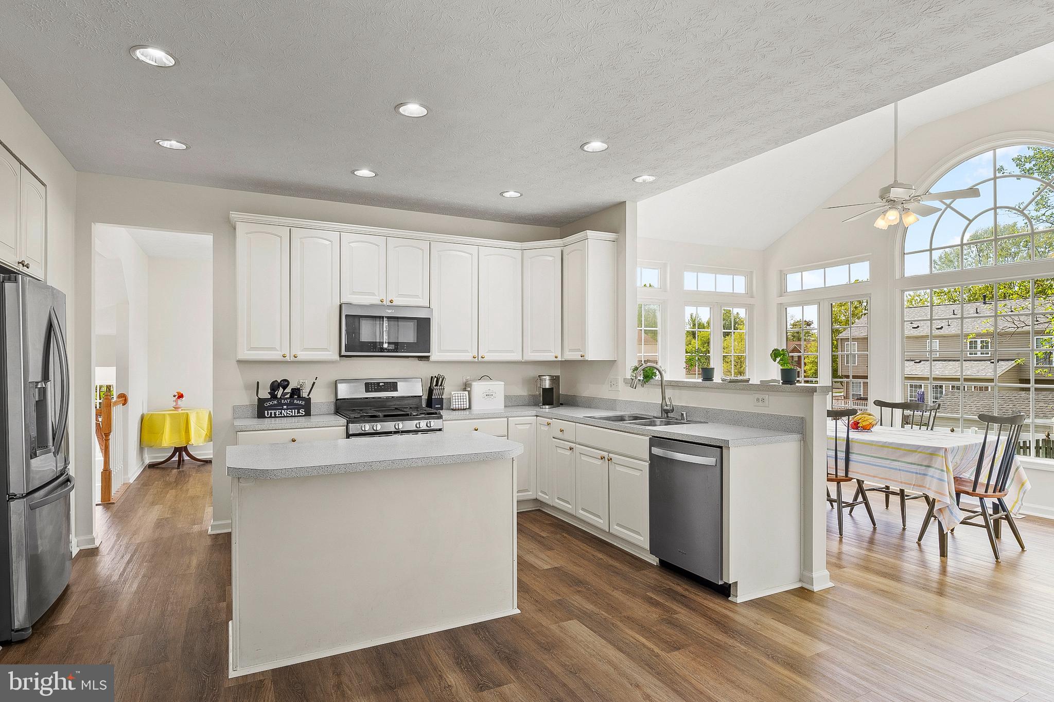 456 North Patuxent Road Odenton, MD 21113 - Photo 9 of 44 a kitchen with stainless steel appliances granite countertop a stove top oven a sink a refrigerator and white cabinets with wooden floor