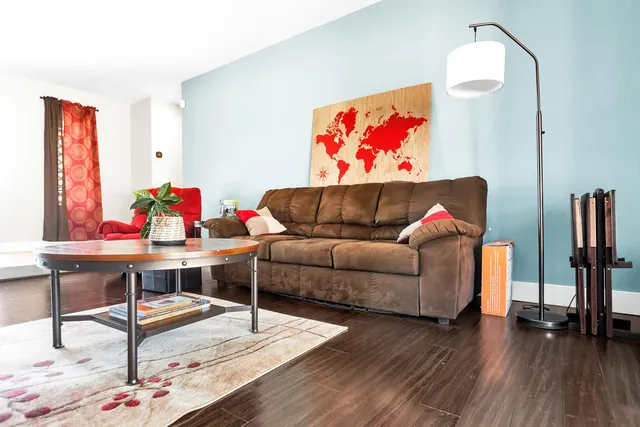 a living room with furniture and wooden floor