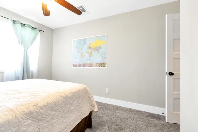 a bedroom with a bed and a window