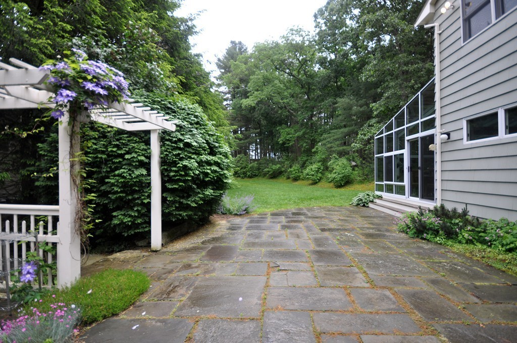 138 Tower Road Lincoln, MA 01773 - Photo 20 of 23 a view of a porch with potted plants and floor to ceiling window