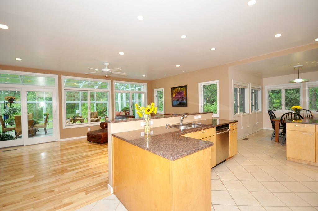 138 Tower Road Lincoln, MA 01773 - Photo 3 of 23 a view of a living room and kitchen with a large window