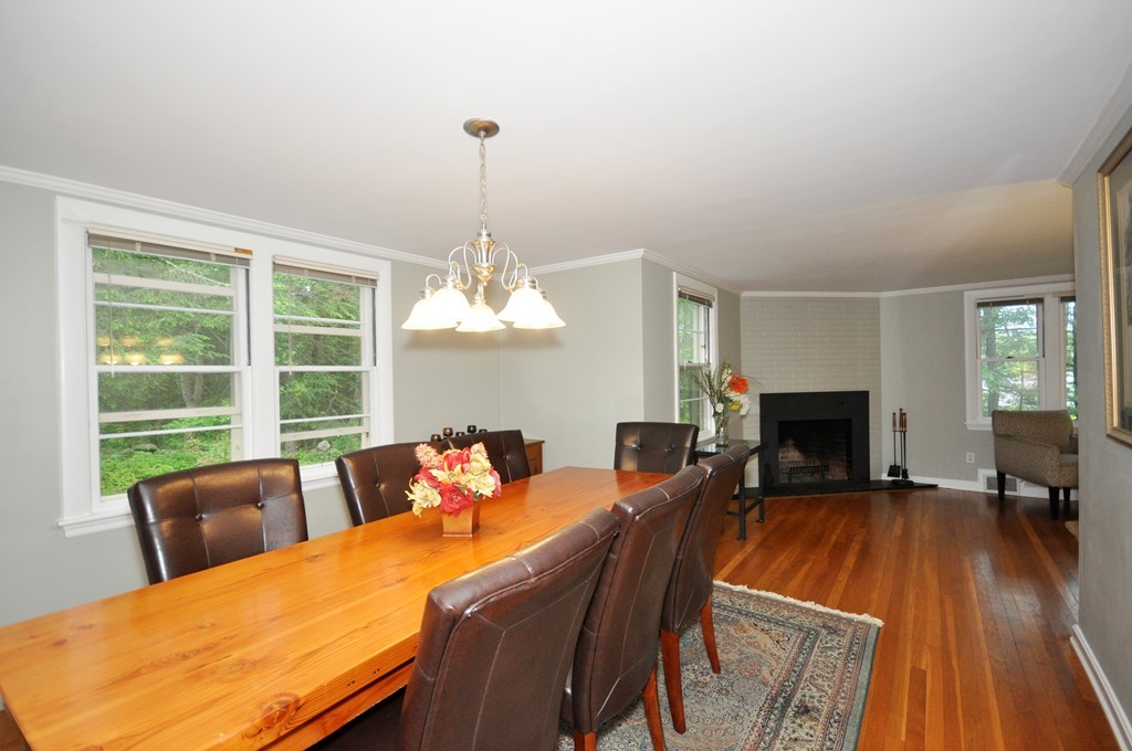 138 Tower Road Lincoln, MA 01773 - Photo 8 of 23 a view of a dining room with furniture a chandelier and wooden floor