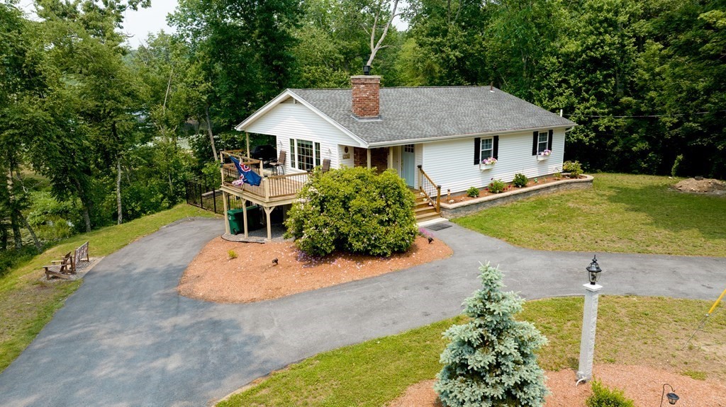 a aerial view of a house with yard patio and garden