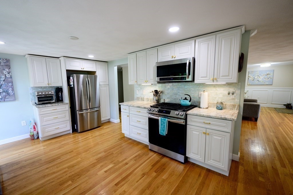 462 Goldthwaite Road Northbridge, MA 01588 - Photo 20 of 40 a kitchen with granite countertop a refrigerator stove top oven and sink