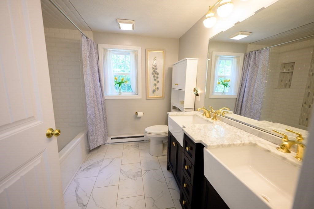 462 Goldthwaite Road Northbridge, MA 01588 - Photo 22 of 40 a spacious bathroom with a granite countertop sink a toilet a mirror and shower
