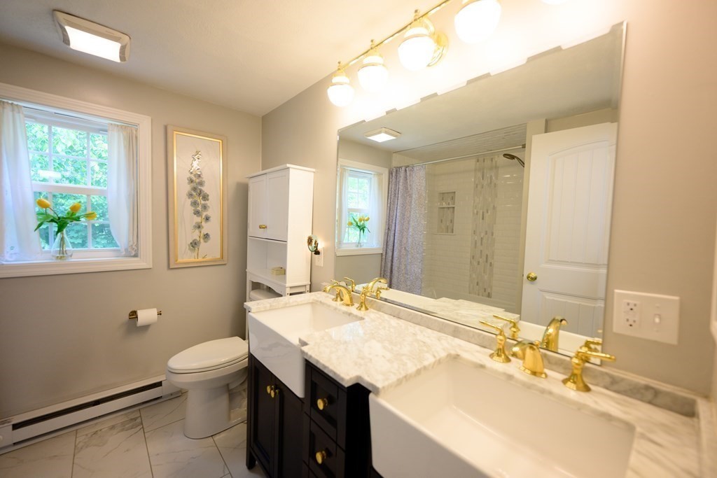 462 Goldthwaite Road Northbridge, MA 01588 - Photo 23 of 40 a bathroom with a granite countertop sink a toilet a mirror and shower