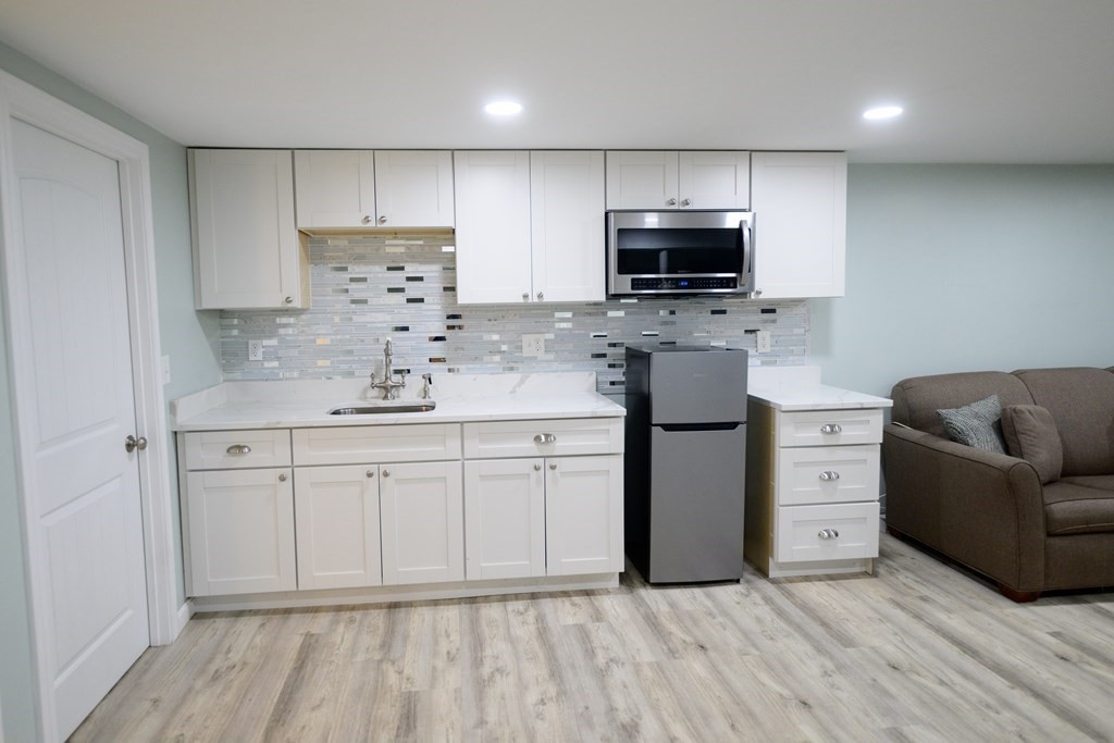 462 Goldthwaite Road Northbridge, MA 01588 - Photo 34 of 40 a kitchen with stainless steel appliances granite countertop a refrigerator sink and microwave