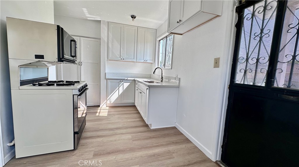 532 West Markland Drive Monterey Park, CA 91754 - Photo 3 of 7 a kitchen with stainless steel appliances a refrigerator stove and sink