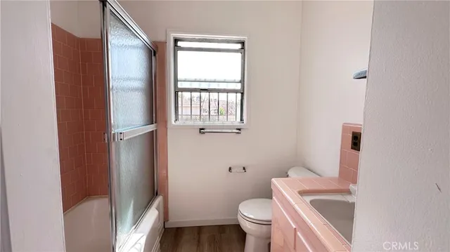a white toilet sitting next to a bathroom sink