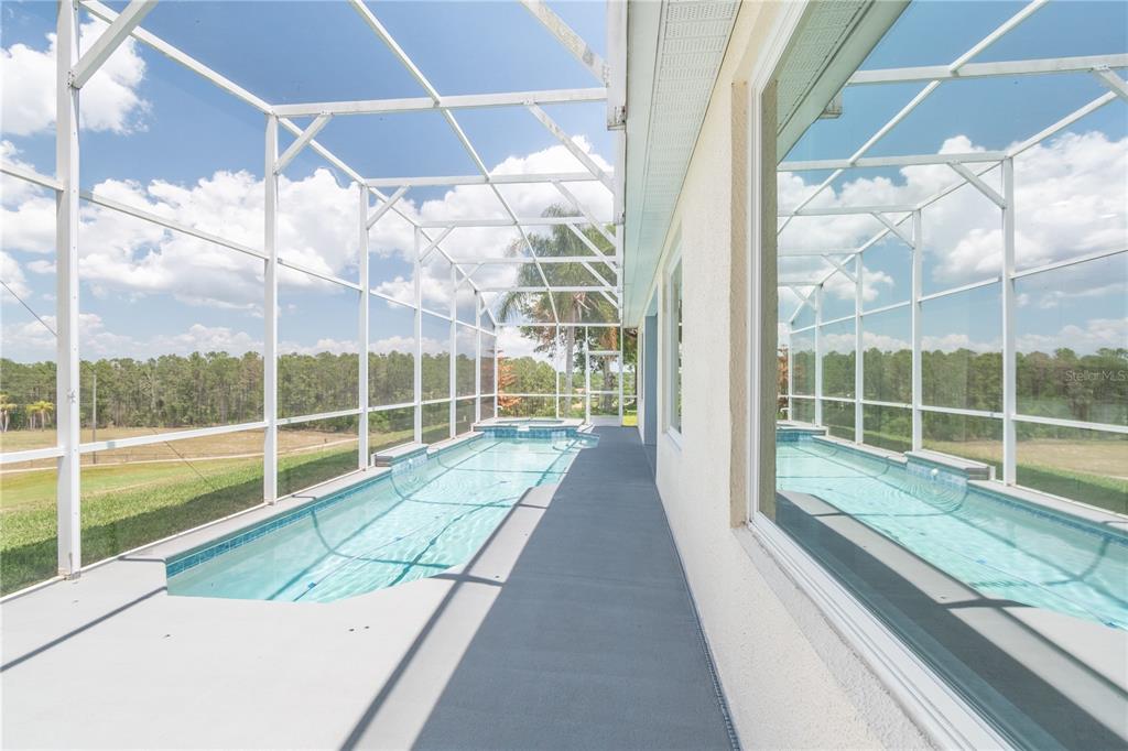 3862 Beacon Ridge Way Clermont, FL 34711 - Photo 47 of 56 a view of a balcony with a floor to ceiling window with wooden floor