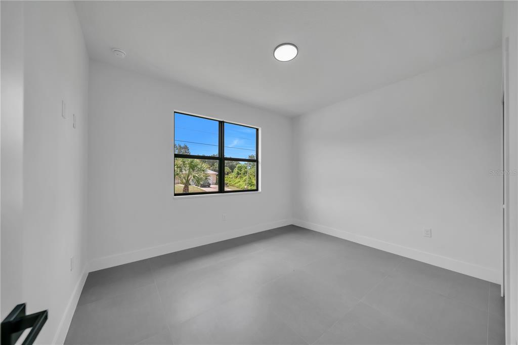 2328 Irondale Road North Port, FL 34287 - Photo 22 of 45 an empty room with windows