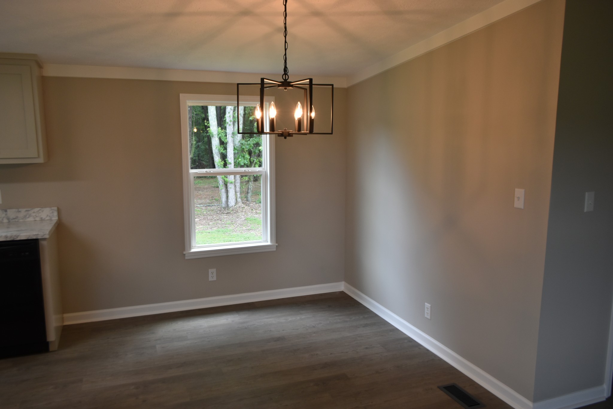 149 Harbin Road Fayetteville, TN 37334 - Photo 6 of 12 a view of an empty room with wooden floor chandeliers and a window