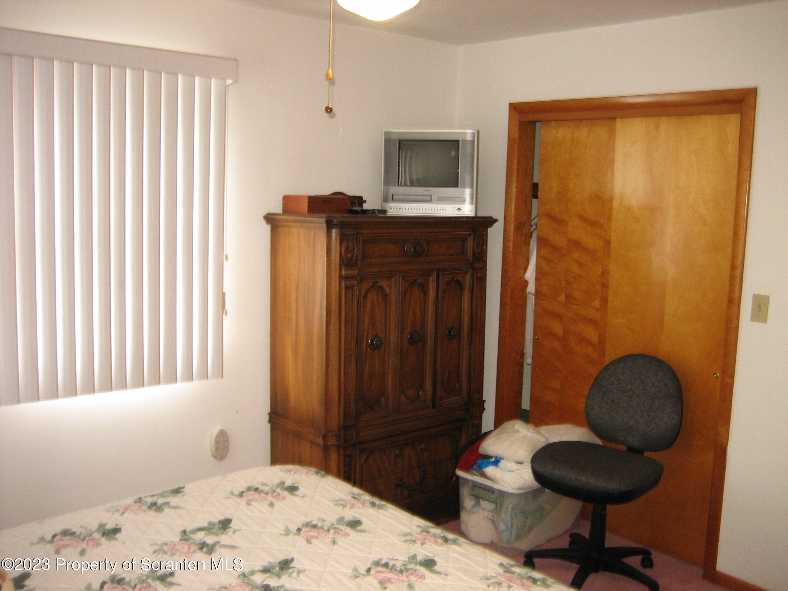 711 3rd Street Eynon, PA 18403 - Photo 11 of 29 a bedroom with a bed and a chair