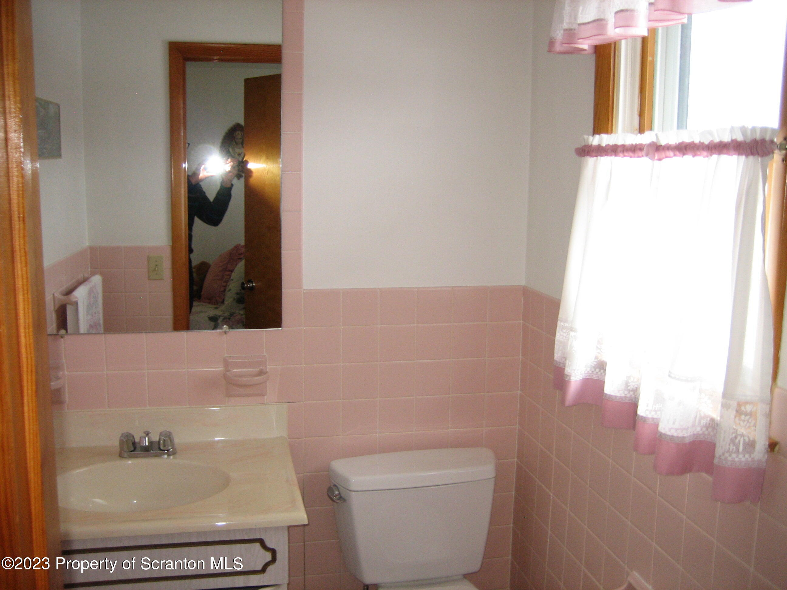 711 3rd Street Eynon, PA 18403 - Photo 12 of 29 a bathroom with a toilet and a mirror