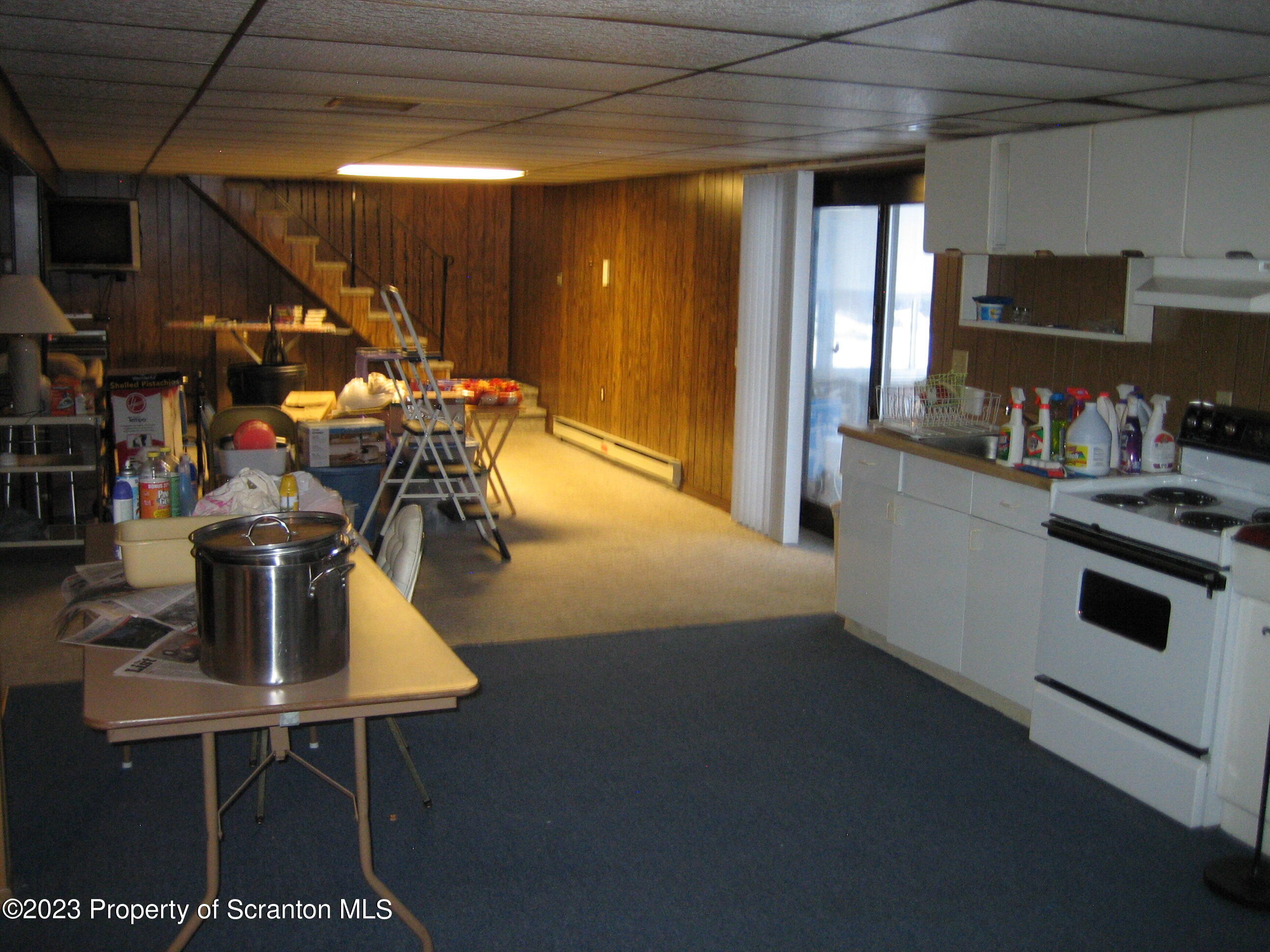711 3rd Street Eynon, PA 18403 - Photo 20 of 29 a kitchen with stainless steel appliances a sink a table chairs and a refrigerator