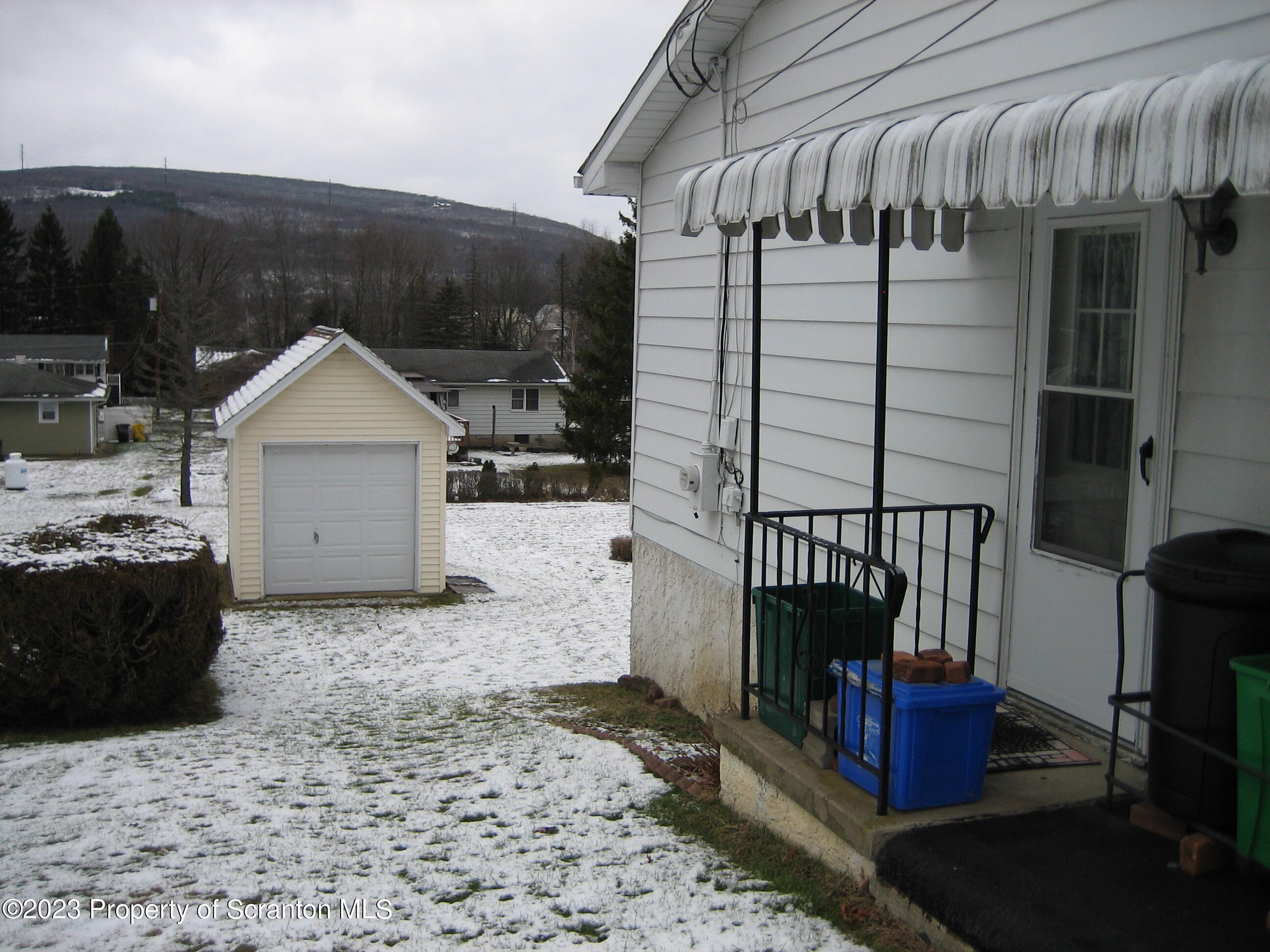 711 3rd Street Eynon, PA 18403 - Photo 27 of 29 a view of a house with a door and wooden fence