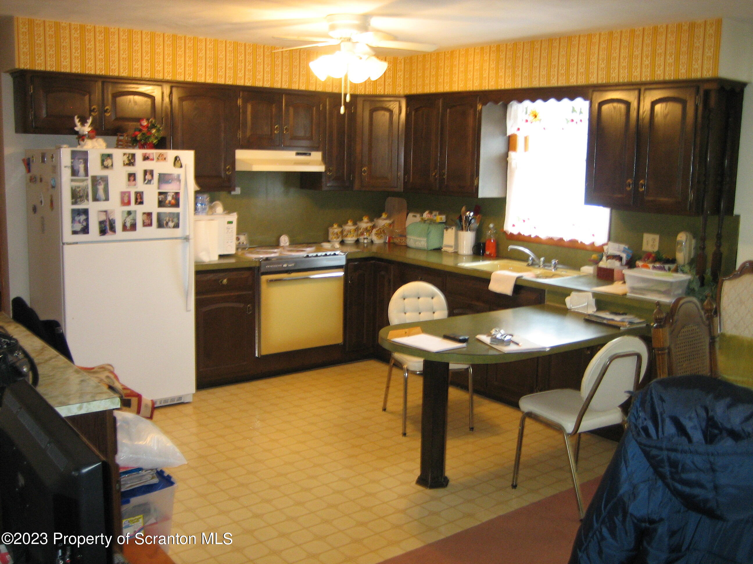 711 3rd Street Eynon, PA 18403 - Photo 3 of 29 a kitchen with stainless steel appliances granite countertop a sink refrigerator stove and microwave