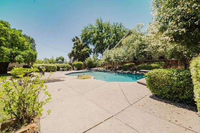 a view of a a dining room with furniture window and wooden floor