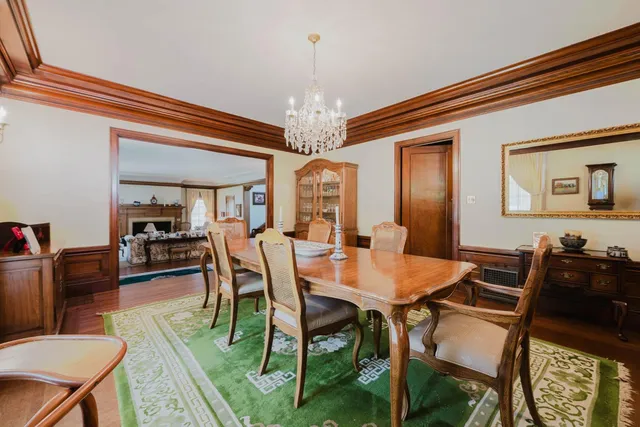 a view of a hallway with wooden floor and stairs