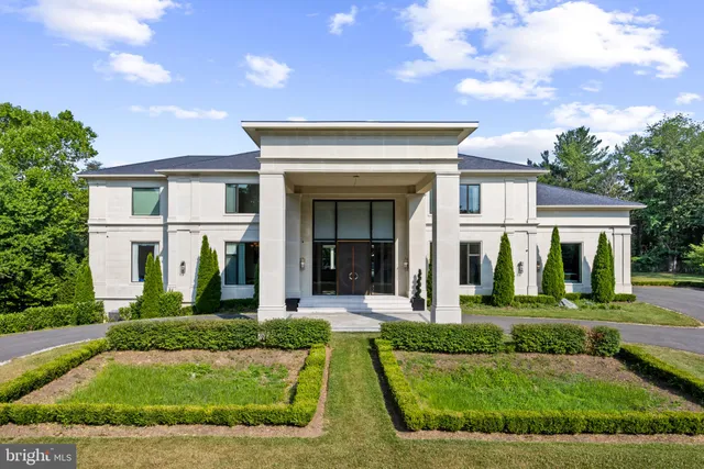 a view of a house with a small yard and large tree