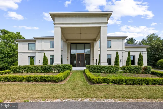 a view of a house with a backyard and a patio