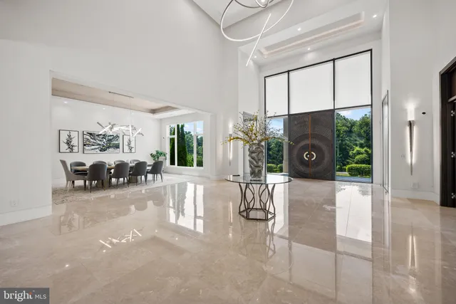a living room with furniture a fireplace and a large window