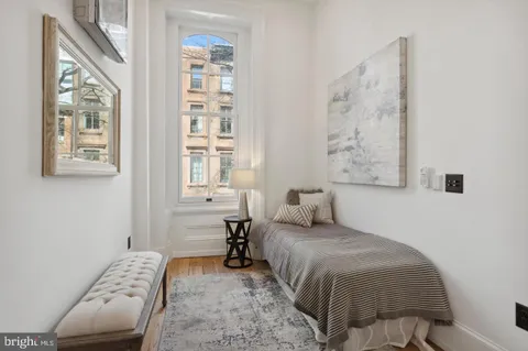 a bedroom with a bed and a couch