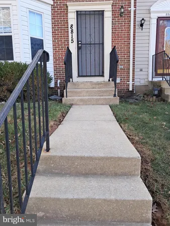 a view of entrance gate of house and green space