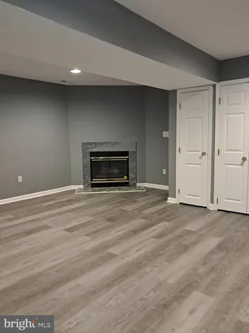 a room with a fireplace and wooden floor