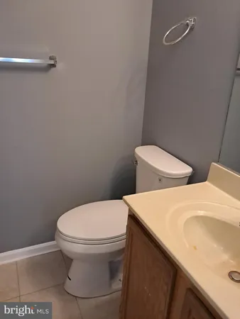 a white toilet sitting next to a bathroom sink