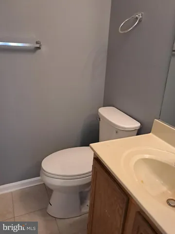 a white toilet sitting next to a bathroom sink