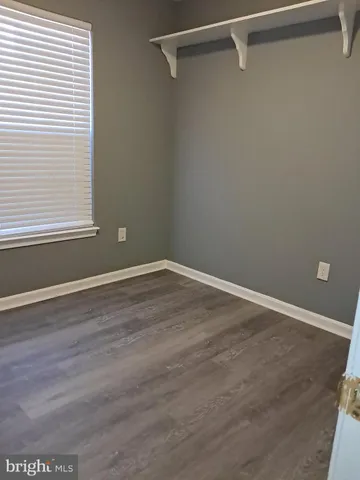 a view of a room with wooden floor and windows