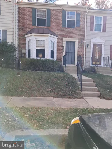 a view of a refrigerator in kitchen and an empty space