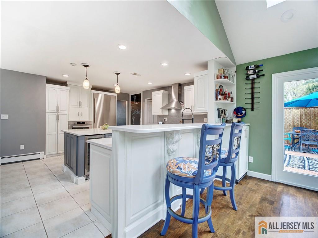 4 Cherokee Road East Brunswick, NJ 08816 - Photo 14 of 40 a kitchen with stainless steel appliances kitchen island granite countertop a table chairs sink and cabinets