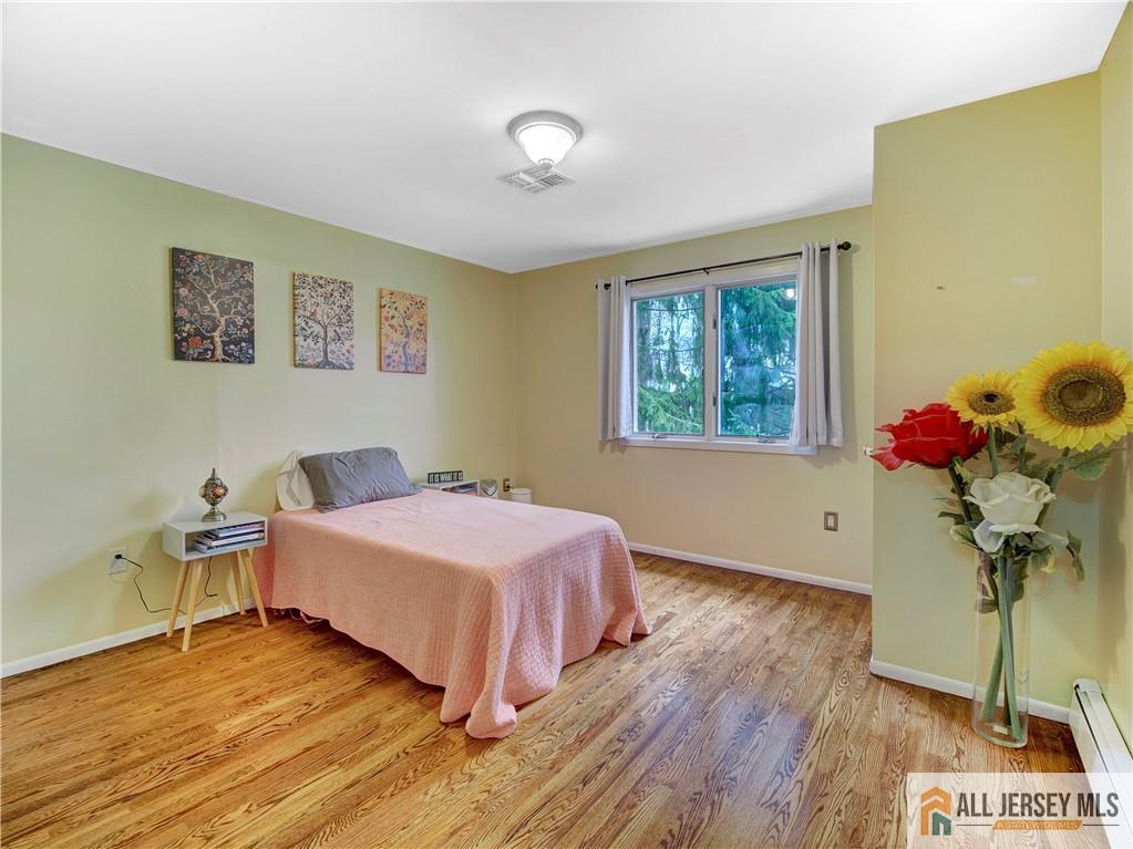 4 Cherokee Road East Brunswick, NJ 08816 - Photo 21 of 40 a bedroom with a bed and a potted plant
